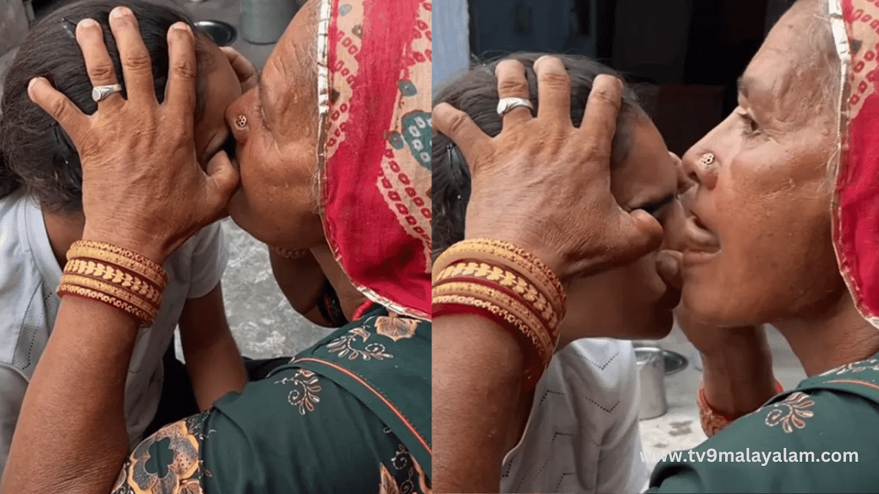 woman cleaning girls eye with her tongue