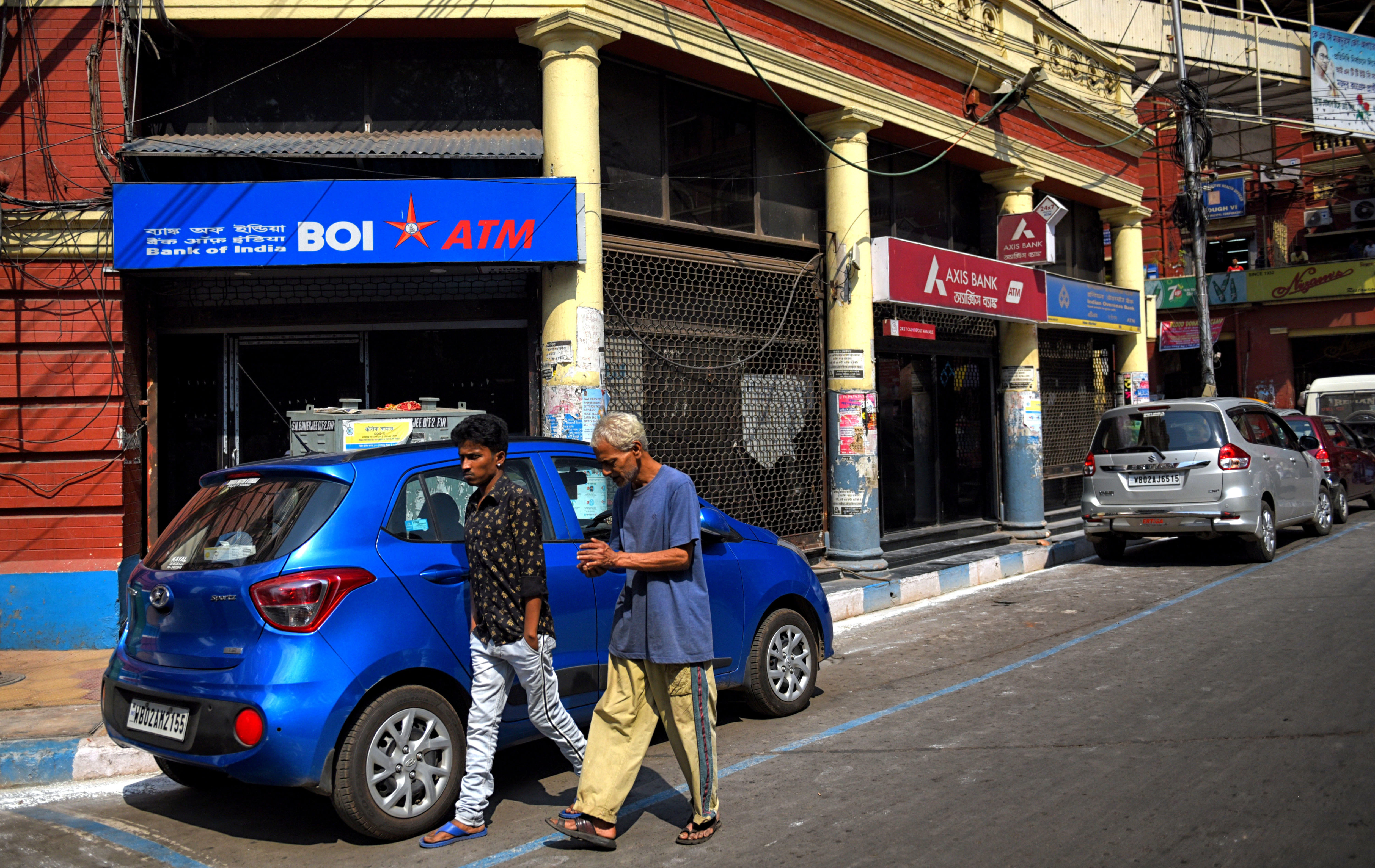 People Walk Past A Bank Of India Atm In Kolkata