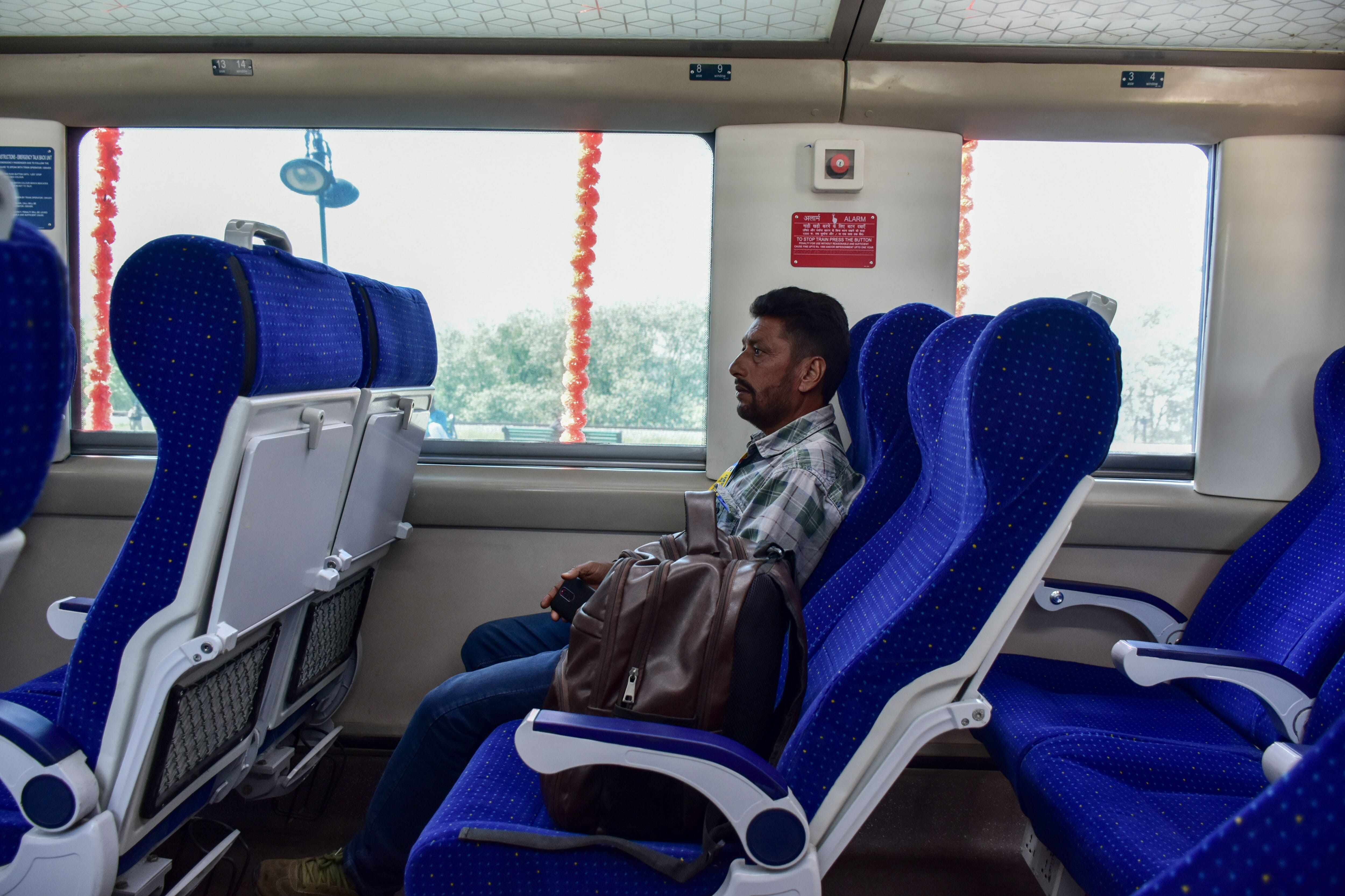 A Passenger Sits Inside The Vande Bharat Express Train At